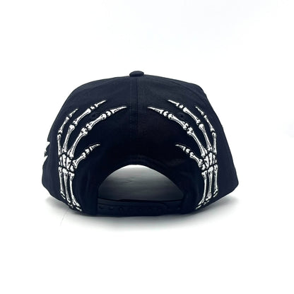 Become Again Skeleton hat, back — skeleton hands at the snap