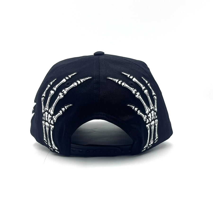 Become Again Skeleton hat, back — skeleton hands at the snap